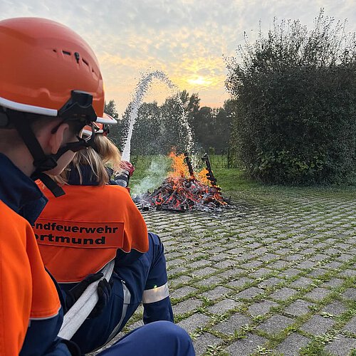 Photo by JF Dortmund-Deusen on September 30, 2025. May be an image of 1 person, fire, helmet, sprinkler, outdoors and text.